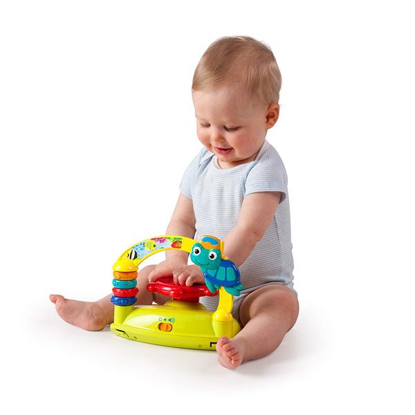 Infant playing with toy station