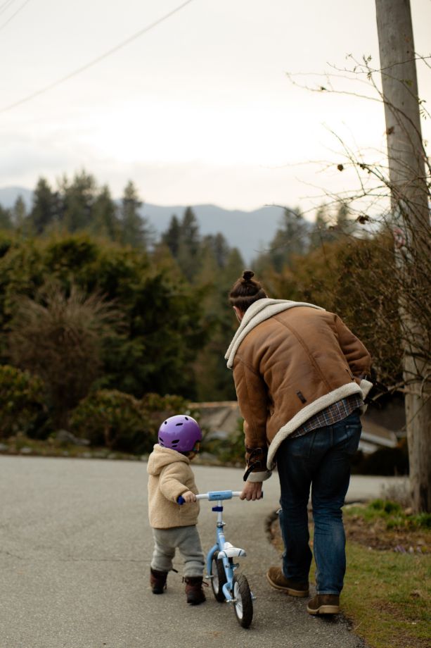 Dad Helping Child for First Bike Ride